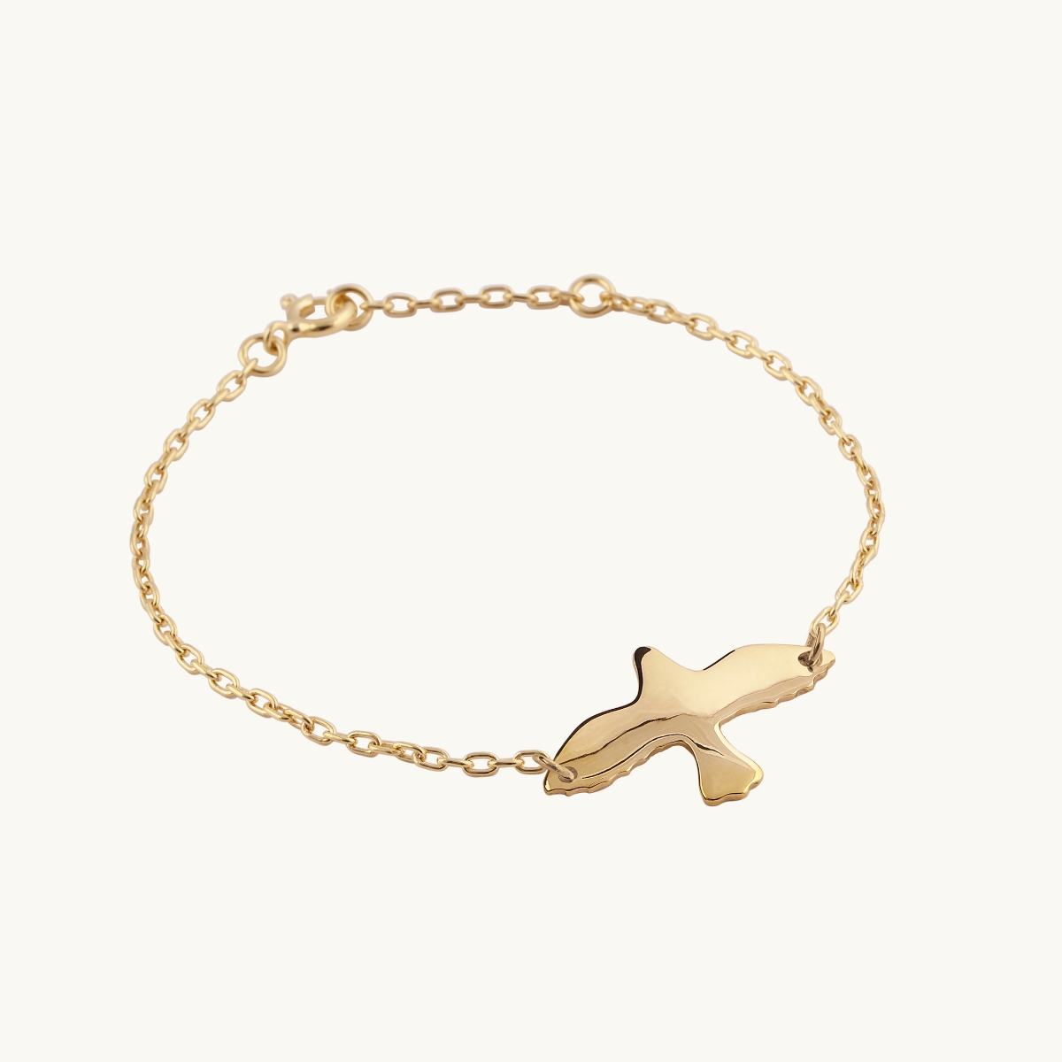 Gold bracelet with a dove pendant