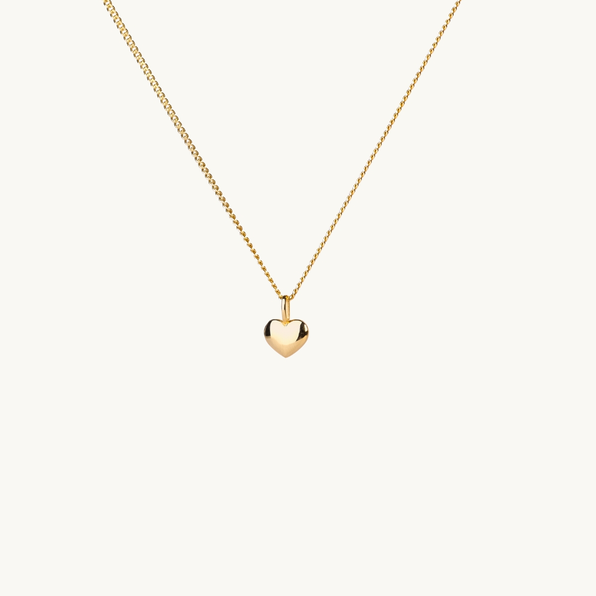 A necklace with a small filled gold heart