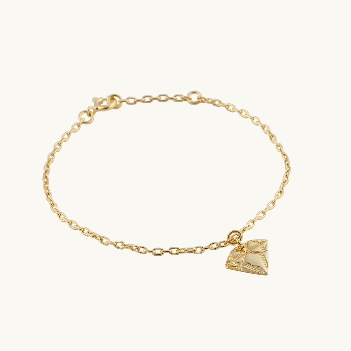 Bracelet in gold plated brass with a diamond pendant