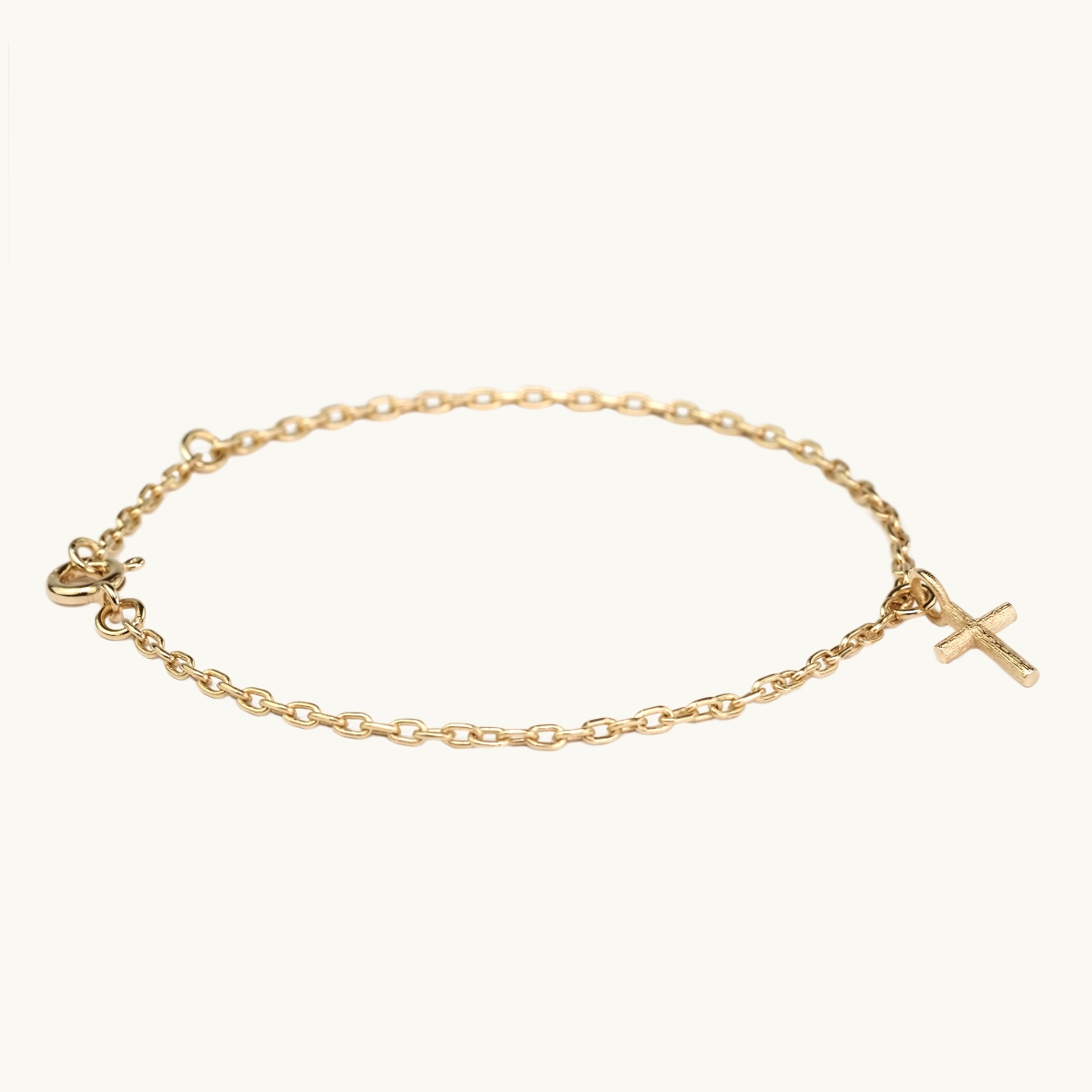Bracelet in gold with a cross pendant