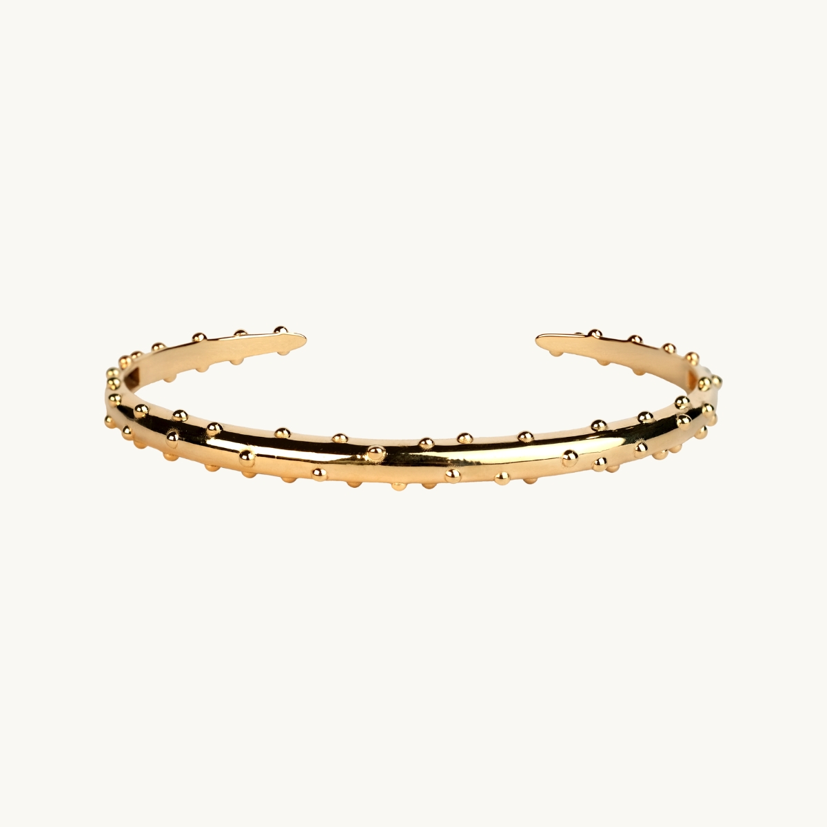A bracelet in gold plated brass with dots