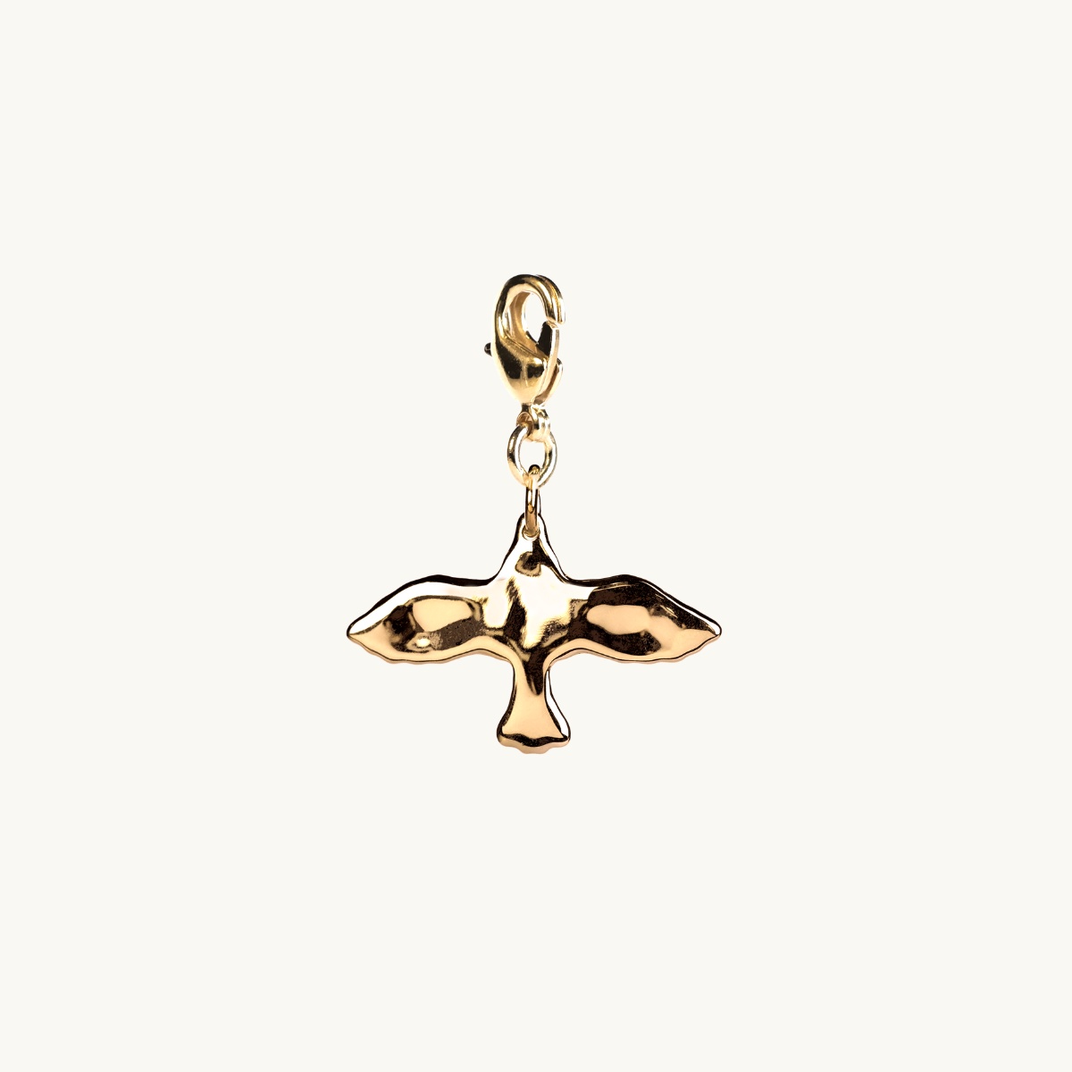 Uneven dove charm in goldplated brass