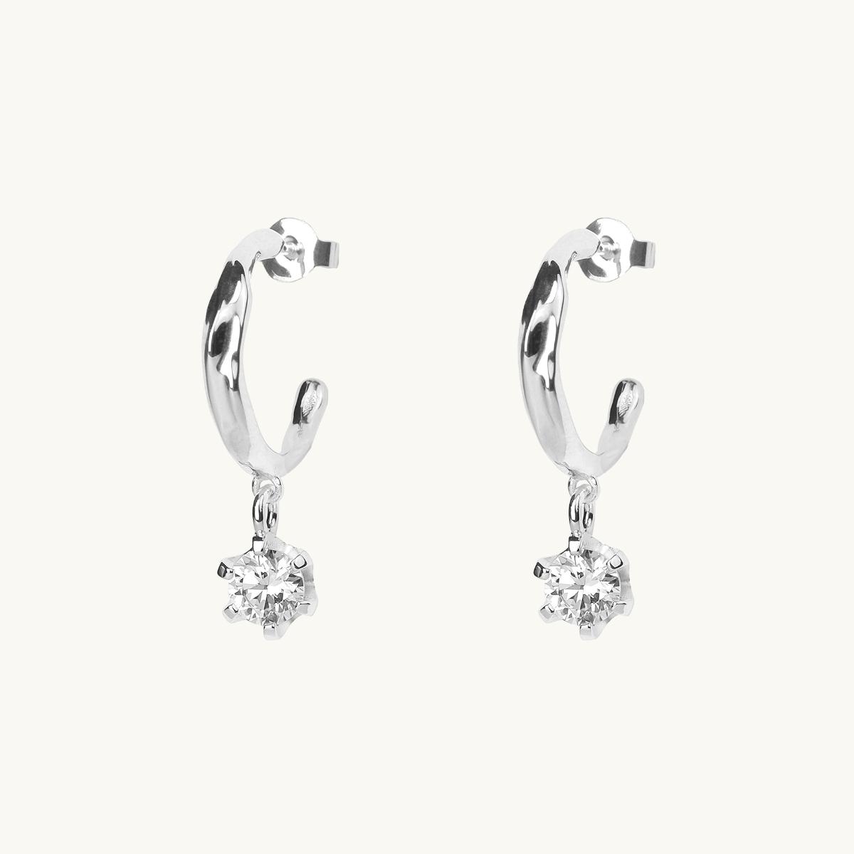 Silver earrings with an organic shape and a white cz stone