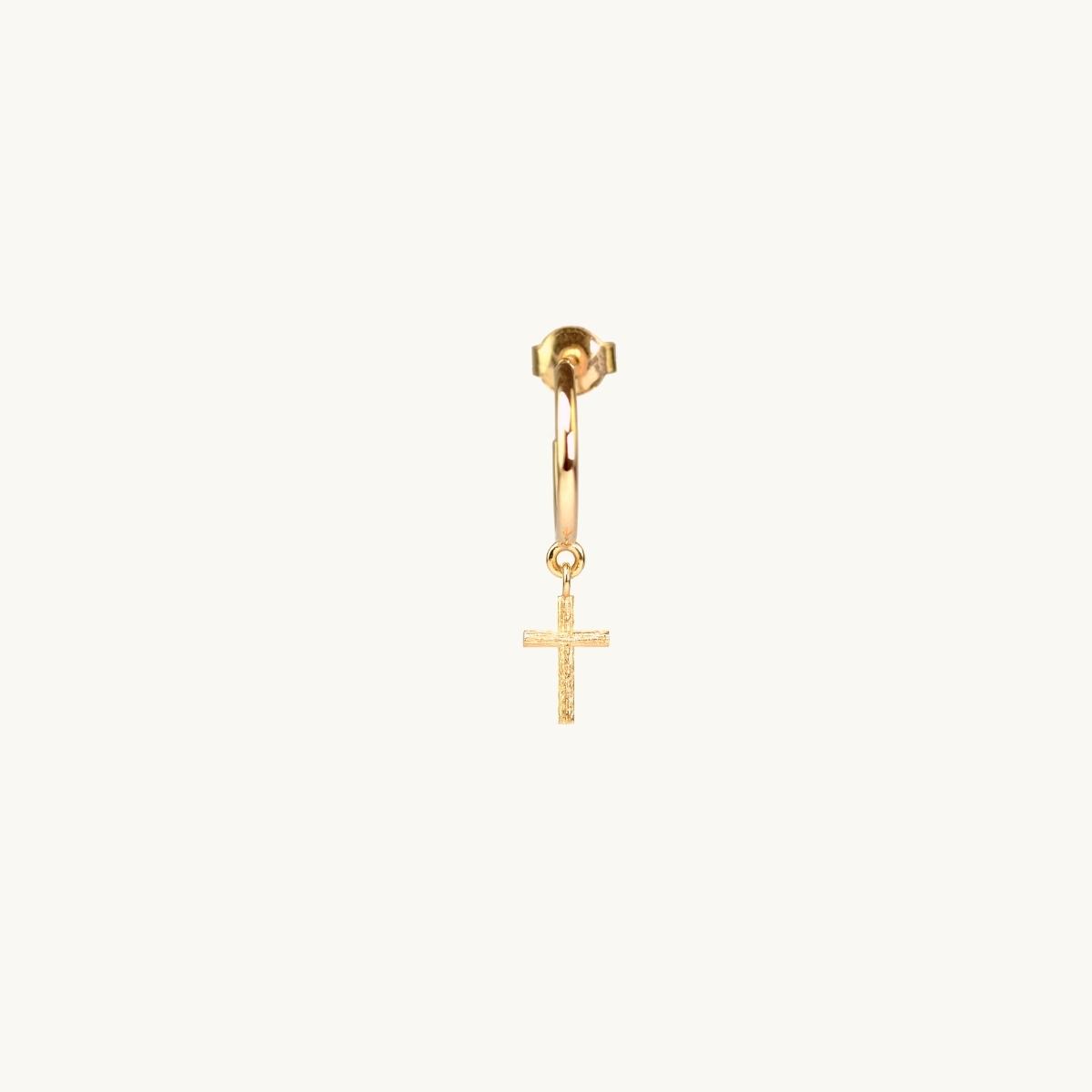 Gold earrings on a hoop with a cross