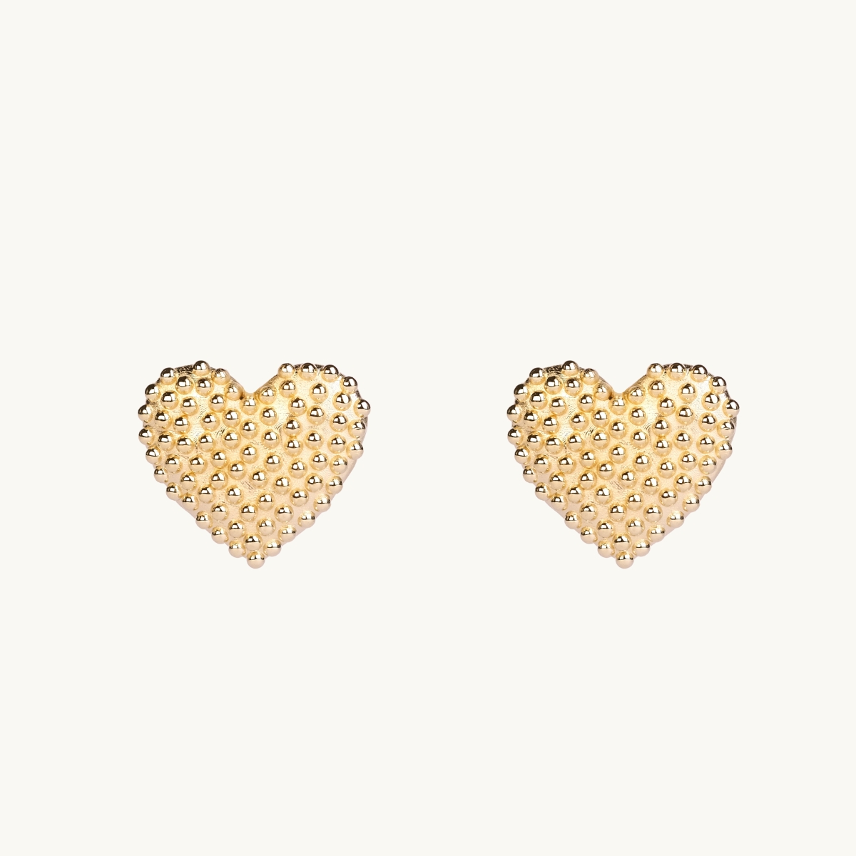 Dew drops on heart earrings in gold.