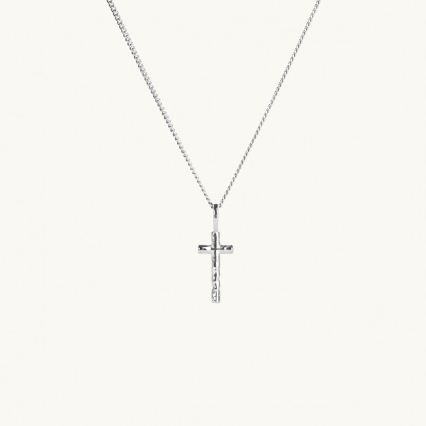 A silver cross with an uneven surface