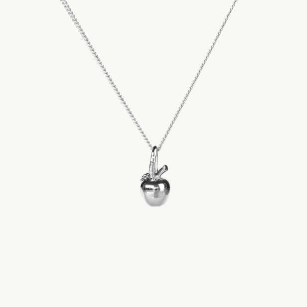 A silver necklace with a pendant in shape of an apple
