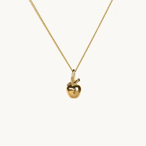 A gold necklace with a pendant in shape of an apple