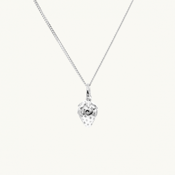 A silver necklace with a pendant in shape of a strawberry