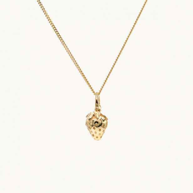A gold necklace with a pendant in shape of a strawberry