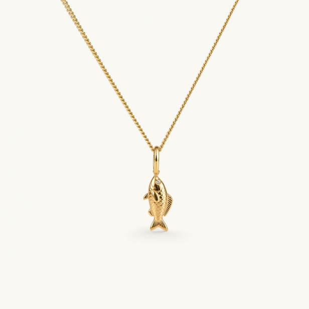 Necklace with a gold colored fish pendant hanging from a chain. The pendant features detailed craftsmanship that captures the fish’s shape and texture. The eyes are set with white CZ stones.