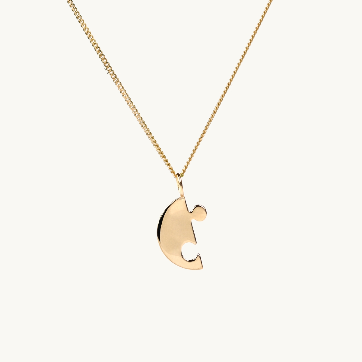 A puzzle necklace in gold