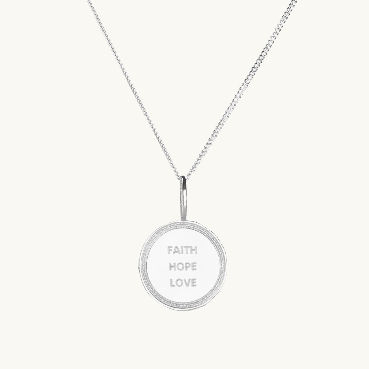 A coin in silver  with the engrave faith, true, love