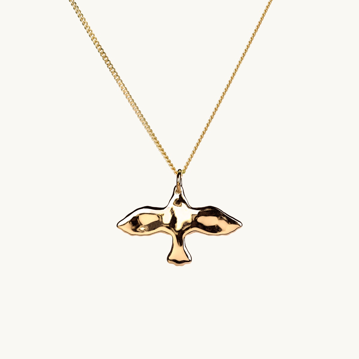 An uneven dove in gold plated brass