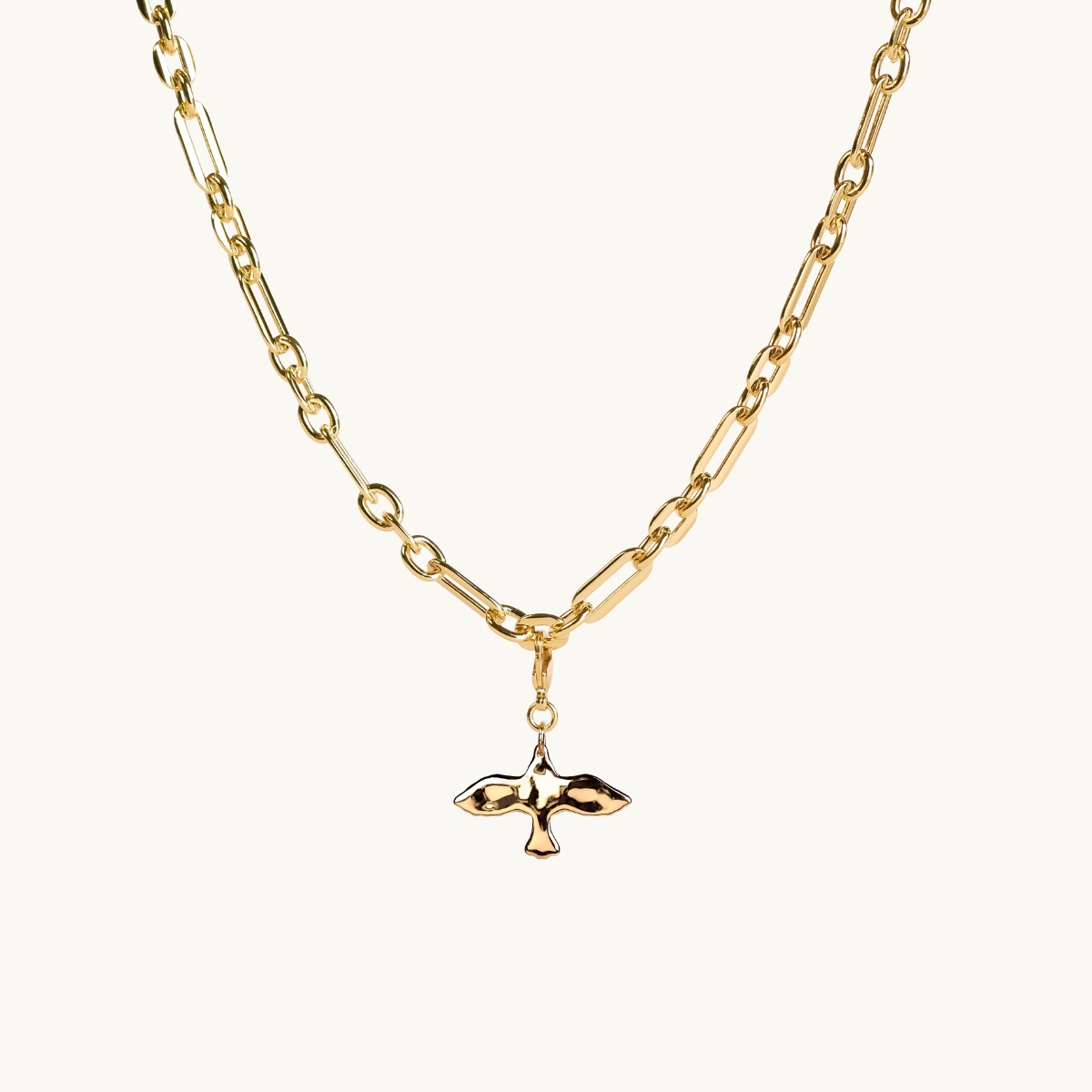 a dove charm on a chunky chain in gold plated brass