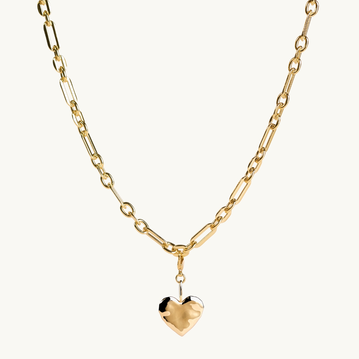 A gold heart on a large chain.