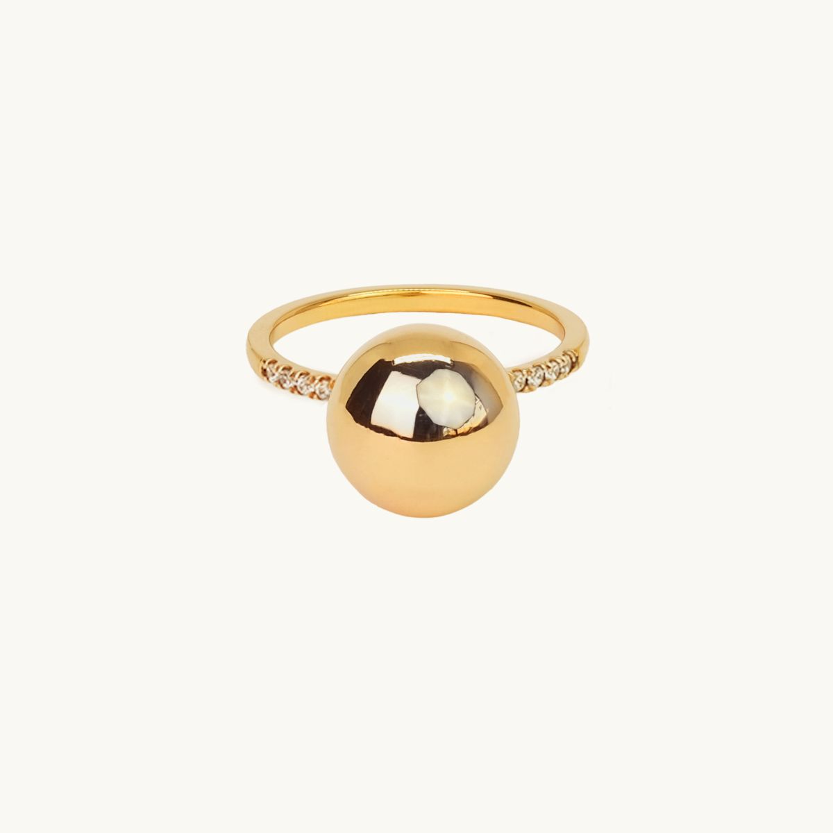 Gold ring with a large globe and white diamonds