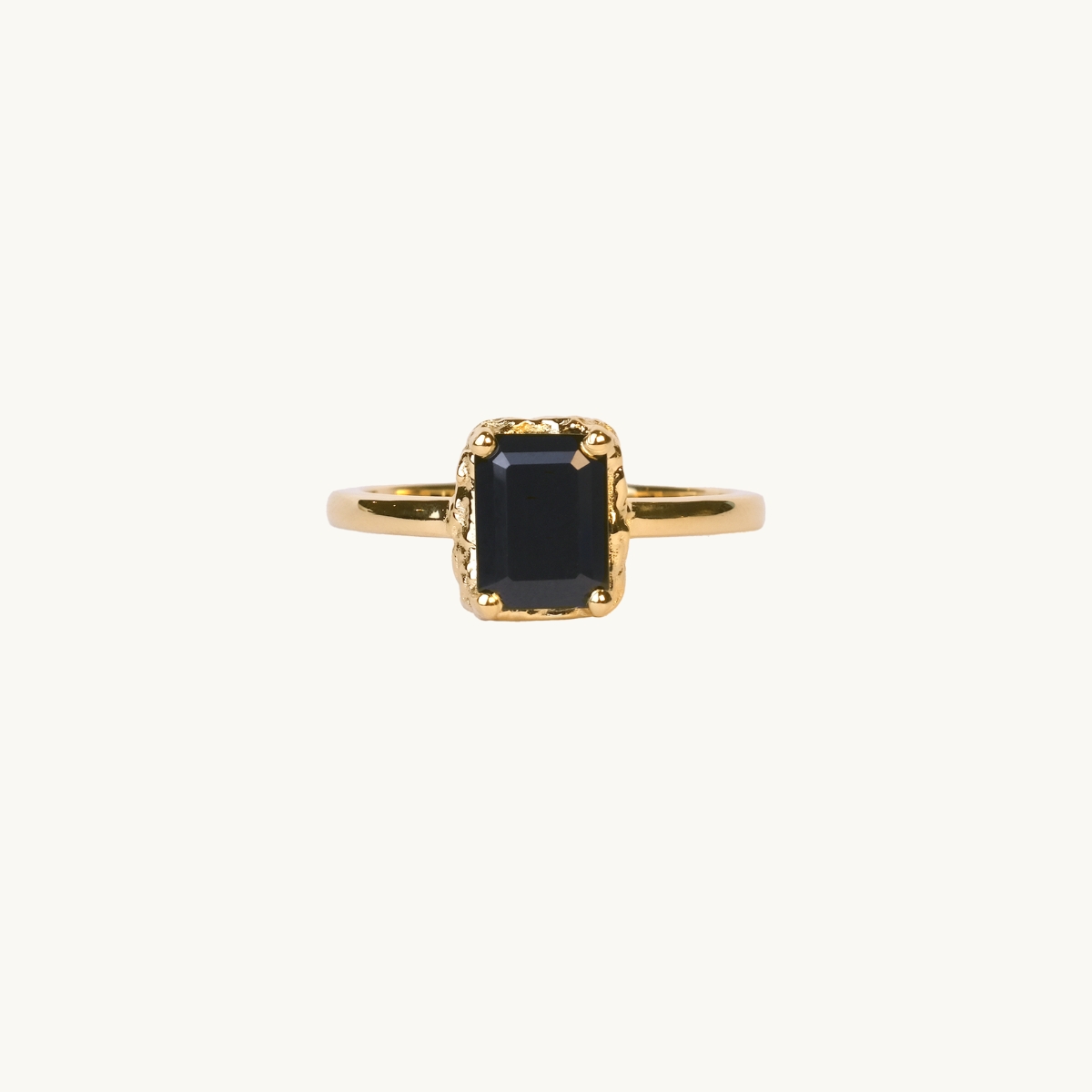 A gold ring with a rectangular black spinel