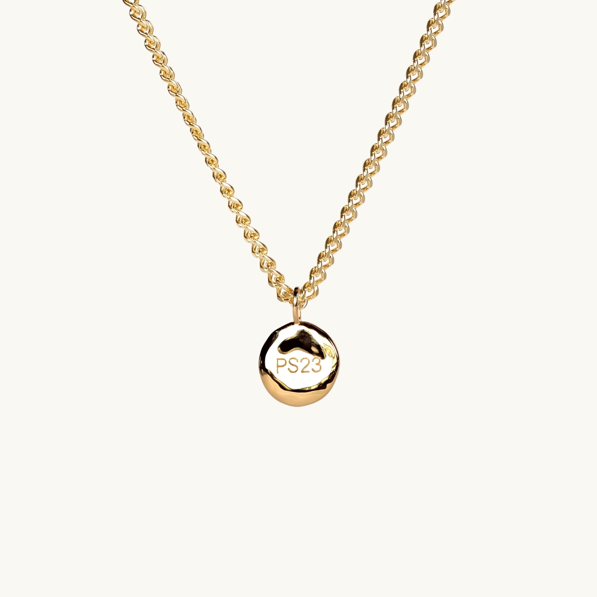 a 18k gold plated brass coin with a bold engraving ps23