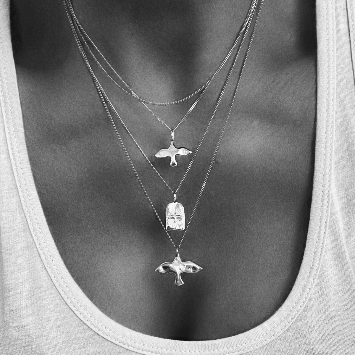 an uneven dove on a necklace