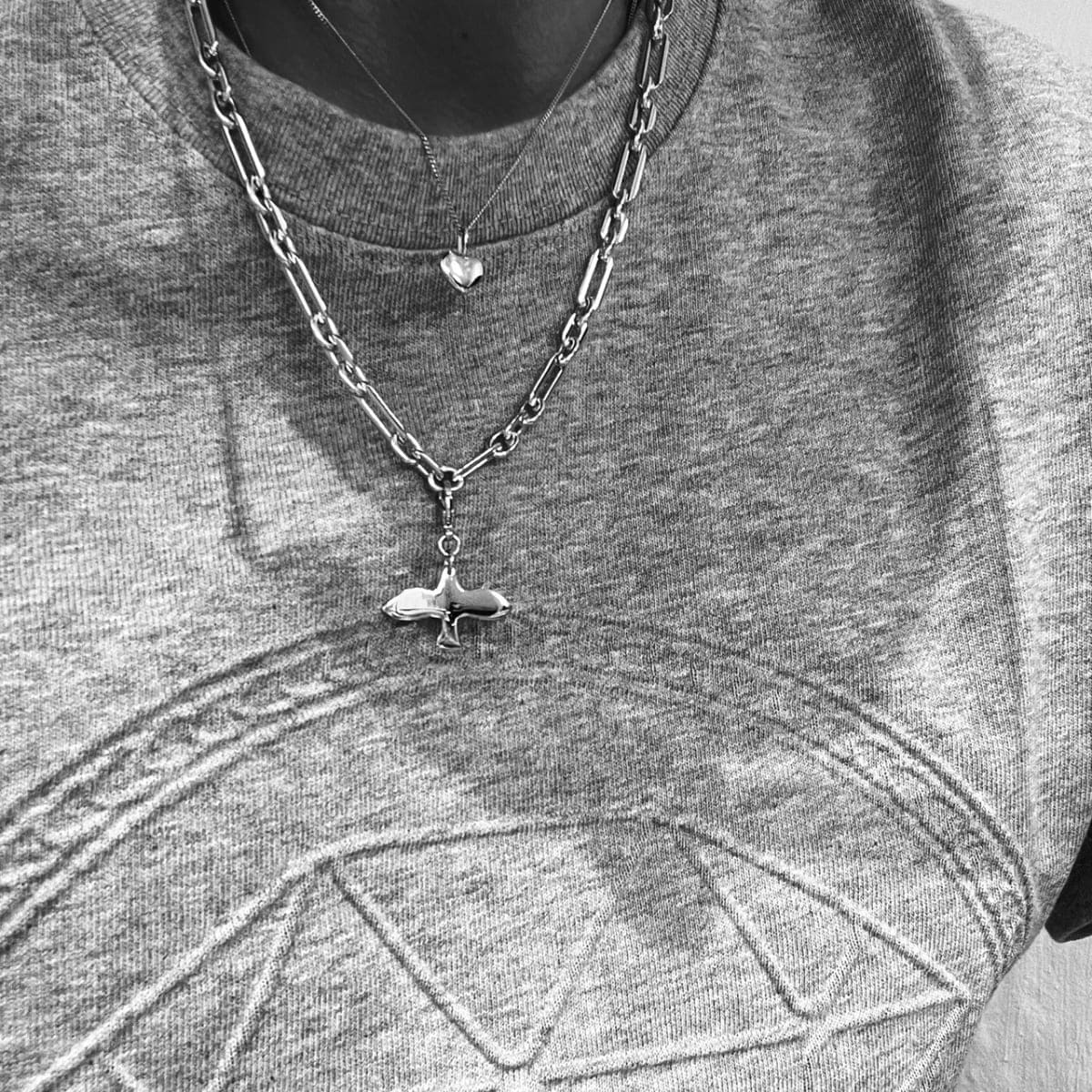 a dove charm on a chunky chain in silver