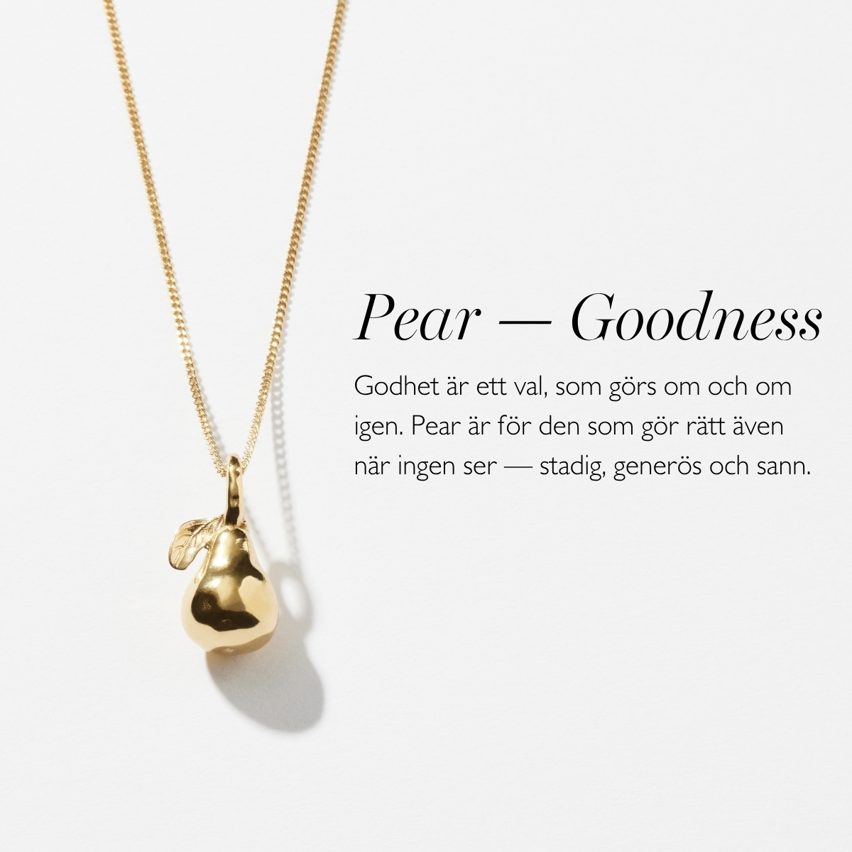 A gold necklace with a pendant in shape of a pear