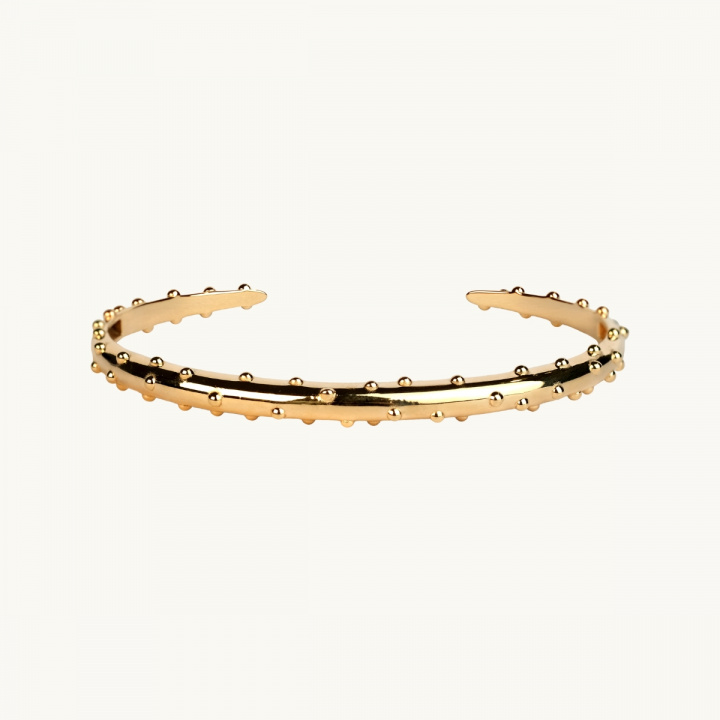 A bracelet in gold plated brass with dots