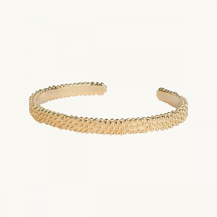Hard bracelet in gold plated brass with an uneven surface