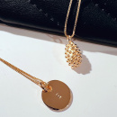 Letter coin in gold on a chain and dew necklace gold