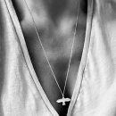 Dove necklace in combination with a cross on model