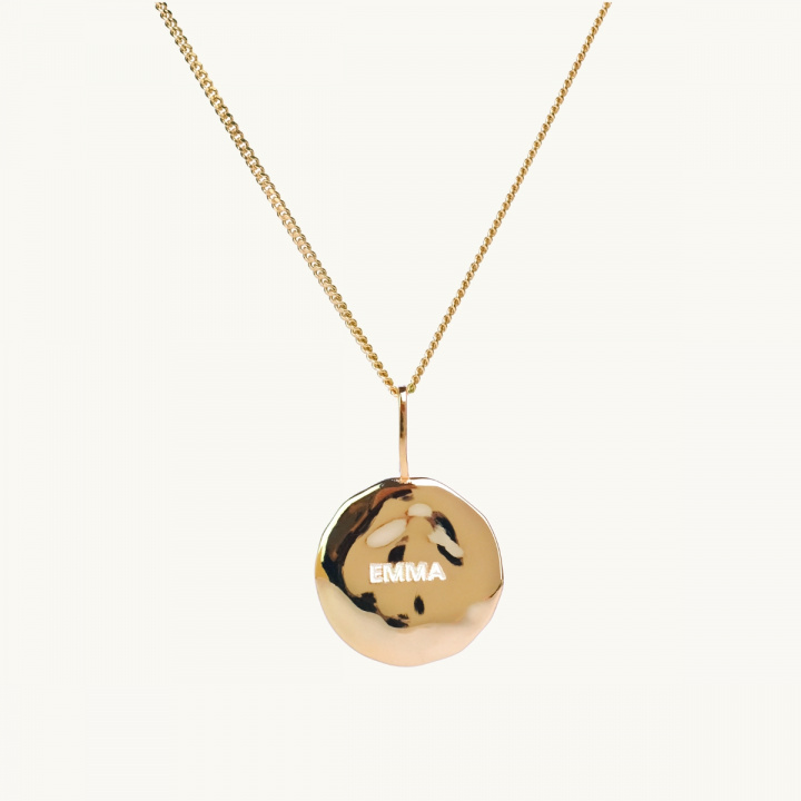 A name coin in gold-plated brass