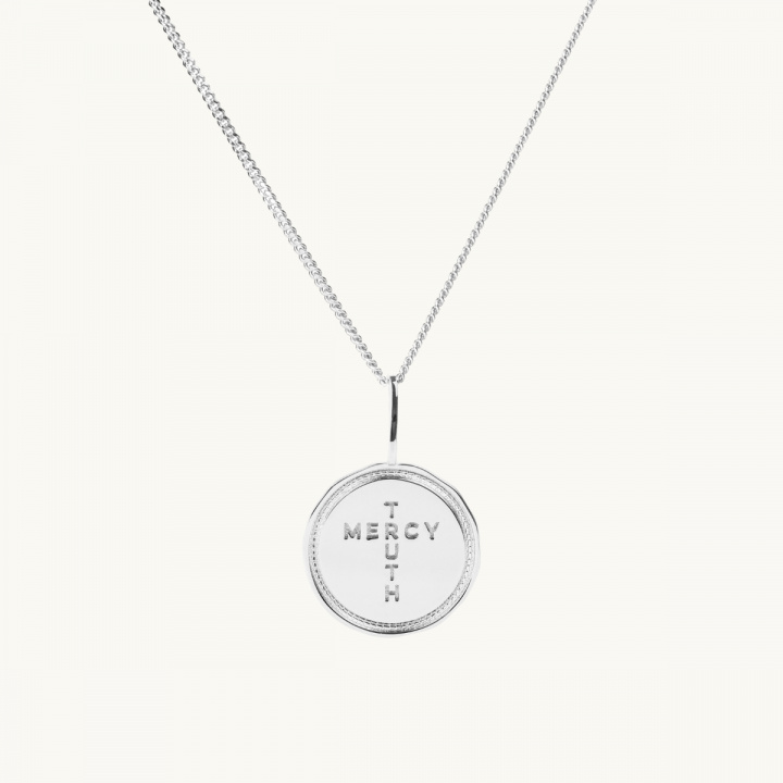 A coin in sterling silver with the inscription Truth Mercy