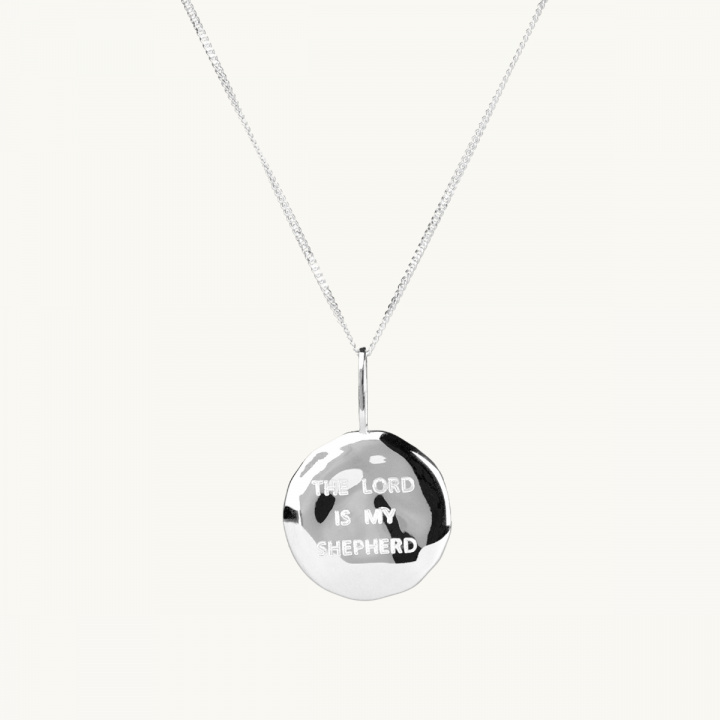 Necklace with a silver coin with an organic shape, with the inscription the lord is my shepherd