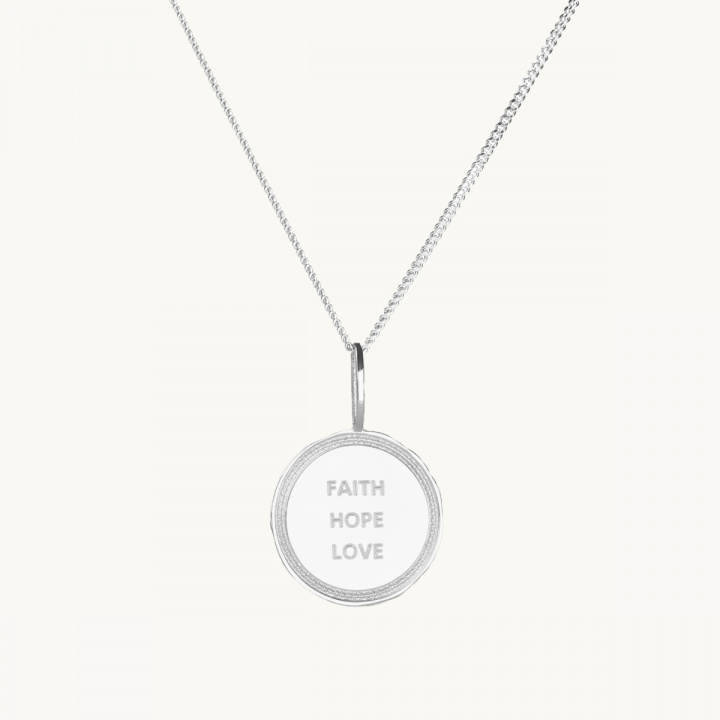 A coin in silver with the engrave faith, true, love