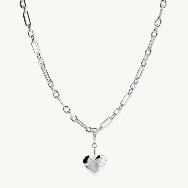 A silver heart on a large chain.