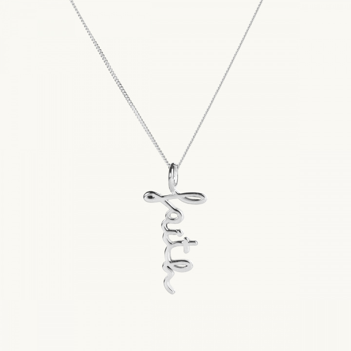 A silver necklace in lowcase letters with the text faith