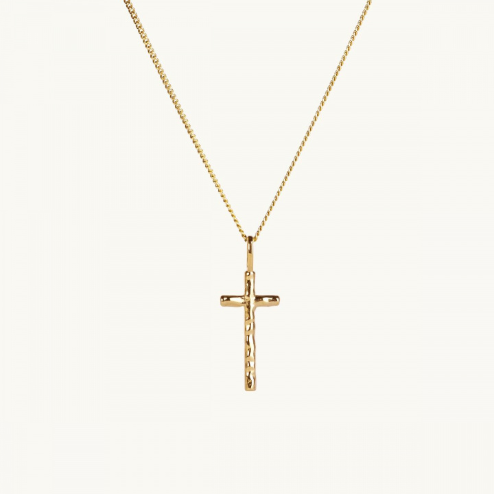 a small gold cross on a chain