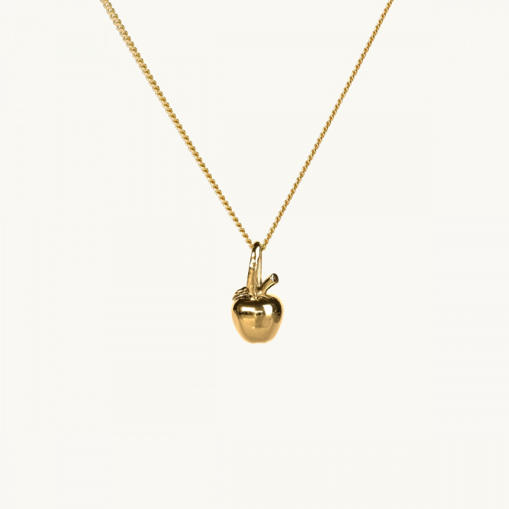 A gold necklace with a pendant in shape of an apple