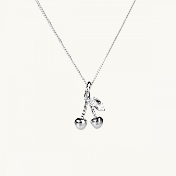 A silver necklace with a pendant in shape of two cherries