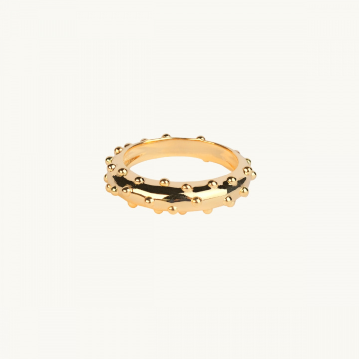 A highly polised gold ring with small dots